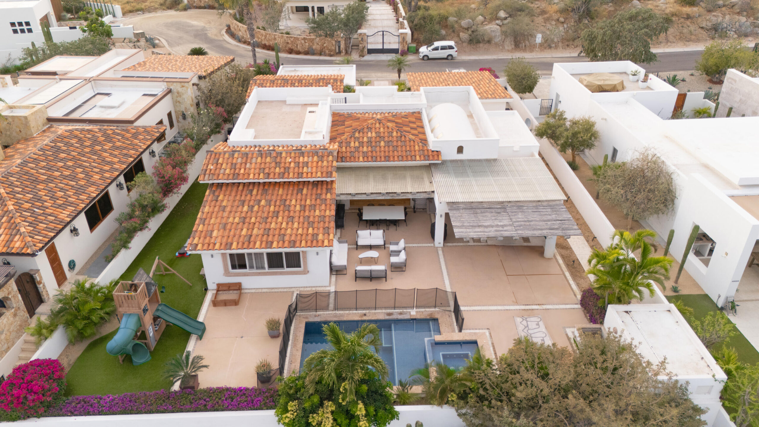 Cabo Luxury Cresta Del Mar Mediterranean-style Home with a poolside bar and generously proportioned patio with its water features, putting green, pool and spa create a playful inviting atmosphere where friends and family will want to gather. Sunset cocktails atop the rooftop deck with its arch for sale