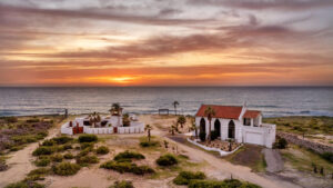 Cabo Luxury Elias Calles Welcome to Rancho 82 -- a rare 2.4-acre oceanfront property offering 190 feet of Pacific coastline, two charming Baja-style homes, and endless potential. With five titled lots, and easy access from Highway 19, this property could become a family compound, boutique retreat, or collection of oceanfront villas. The main home offers 3 bedrooms and 3 baths; the guest casita includes 3 bedrooms, 2 baths, and a rooftop terrace. Both feature authentic Mexican craftsmanship, handmade tiles, and sweeping ocean – 186 Fundadores Puerto Los Cabos, San Jose del Cabo, BS