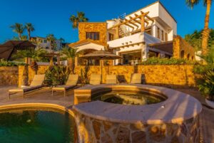 Cabo Luxury Cresta Del Mar Mediterranean-style Home with a poolside bar and generously proportioned patio with its water features, putting green, pool and spa create a playful inviting atmosphere where friends and family will want to gather. Sunset cocktails atop the rooftop deck with its arch – 96 Calle Principal Cresta del Mar, Cabo Corridor, BS