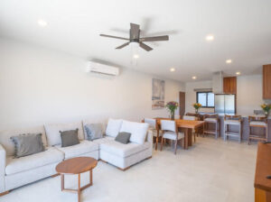 Cabo Luxury Casa Nima Unique 2-bedroom, 2-bathroom condo in Casa Nima featuring a distinctive loft-style design. The main level offers a guest bedroom with a full bathroom, a well-equipped kitchen, and a stunning double-height living area that creates an open and airy feel, seamlessly connecting to a private terrace--perfect for enjoying Cabo's sunsets. Upstairs, the loft-style primary bedroom includes its own full bathroom and overlooks the living area, adding character and charm. Located in Casa Nima, residents enjoy top amenities including a restaurant, yoga area, pickleball courts, coworking space, kids club, and more, all within a beautifully designed low-density community. – Avalon, Cabo Corridor, Cabo Corridor, BS