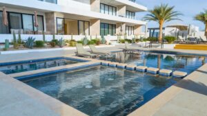 Cabo Luxury Breeze Of Cabo Discover this modern 2-bedroom, 2-bathroom condo located in the highly sought-after Sunset area of Cabo San Lucas. This corner unit offers maximum privacy with only one neighbor and features spacious windows and a cozy terrace where you can enjoy breathtaking sunrises and sunsets. The property includes underground parking, access to a shared rooftop with a swimming pool and panoramic ocean – Vistas del Tezal #504, Cabo Corridor, Cabo Corridor, BS