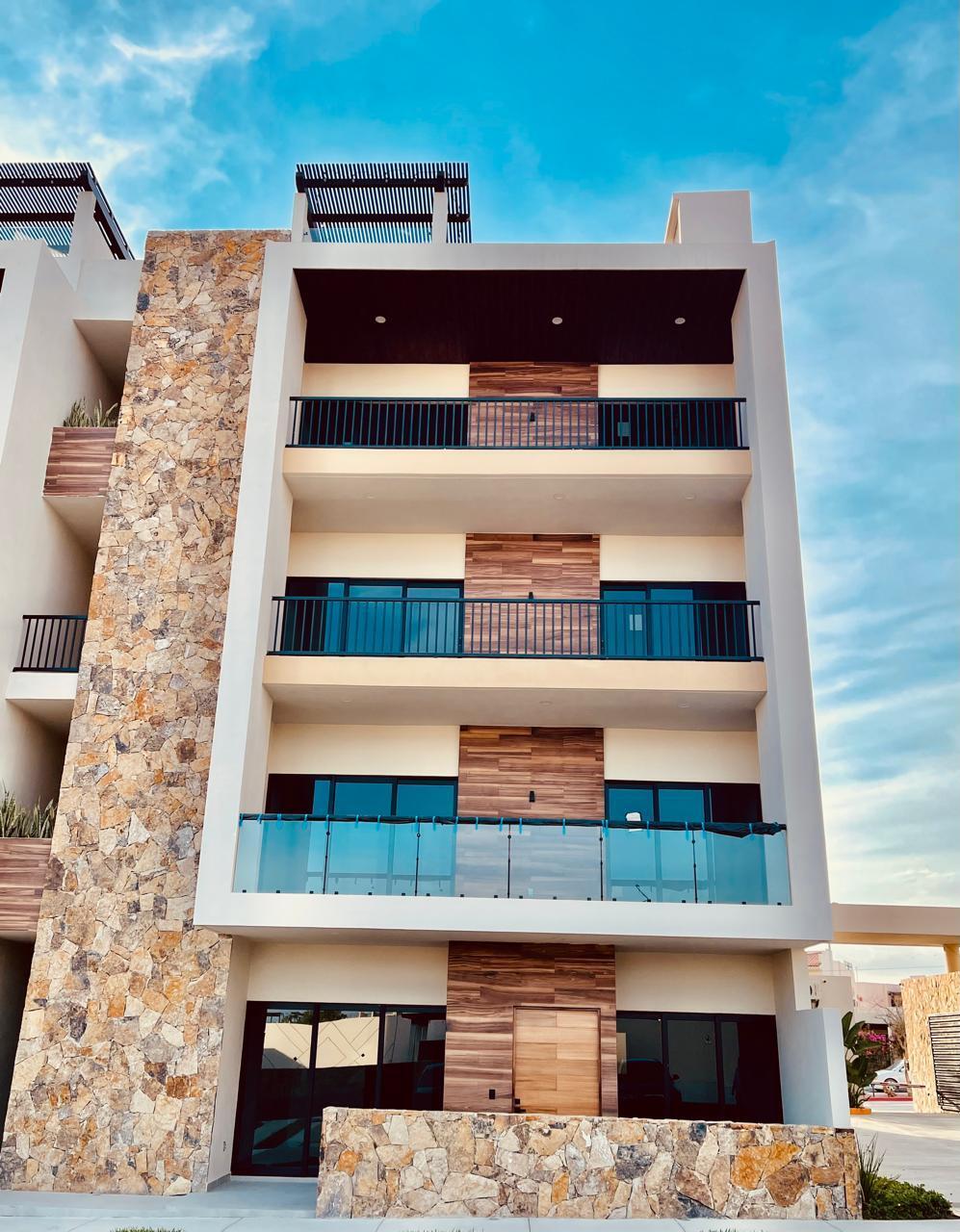 Cabo Luxury Brisas Del Tezal Ready for immediate delivery! Beautiful ground-floor 2BR/2BA condo in Brisas del Tezal, an exclusive low-density community of only 36 residences in two 4-story elevator buildings. Just minutes from Medano Beach, downtown Cabo, shopping, golf, and restaurants. Features premium finishes including marble floors, granite countertops, parota wood carpentry, floor-to-ceiling marble showers, pantry, laundry room, wall-to-wall closets, mini-split A/C throughout, and a spacious terrace. No adjoining side neighbors for exceptional privacy. Resort-style amenities include a heated pool, clubhouse, coworking space with Wi-Fi, BBQ area, playground, landscaped grounds, 24/7 security, and immediate occupancy. Ideal for full-time living, vacation use, or investment. – 2 bedroom Ground-Floor Close to the Pool, Cabo Corridor, BS